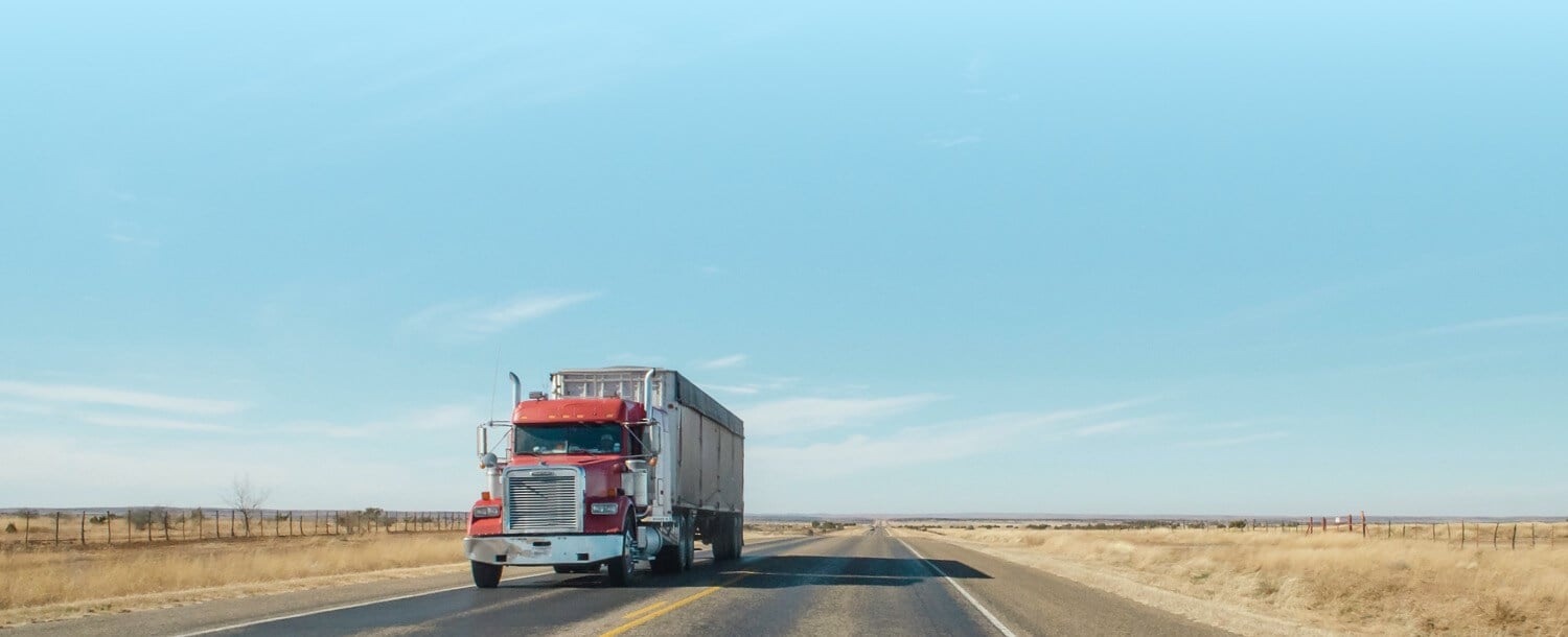 Photo of a truck on open road, symbolizing progress
